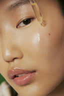 A close-up of a skincare serum drop applied with a dropper for hydration, protection, and calming benefits.
