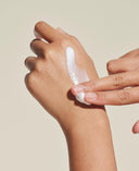 Hand applying luxury cream for hydration, protection, and calming with Audrose® for sensitive skin.