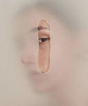 Minimalist image of a woman’s face partially revealed through torn paper, symbolizing sensitivity and protection. with Audrose® for sensitive skin.